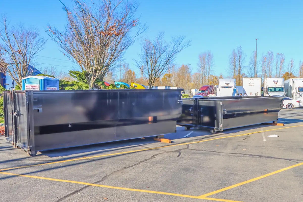 Professional dumpster rental service with roll-off container on residential driveway in Spanish Fort
